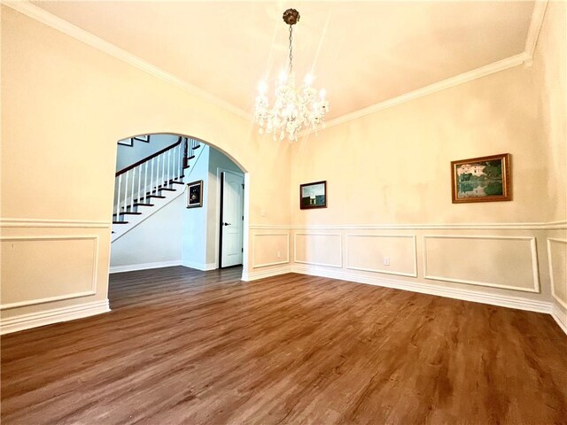 interior space with crown molding, wood-type flooring, and a notable chandelier