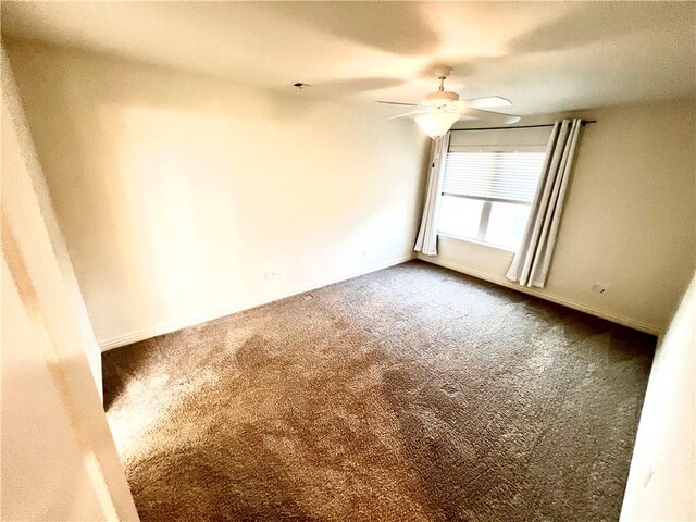 carpeted empty room with ceiling fan