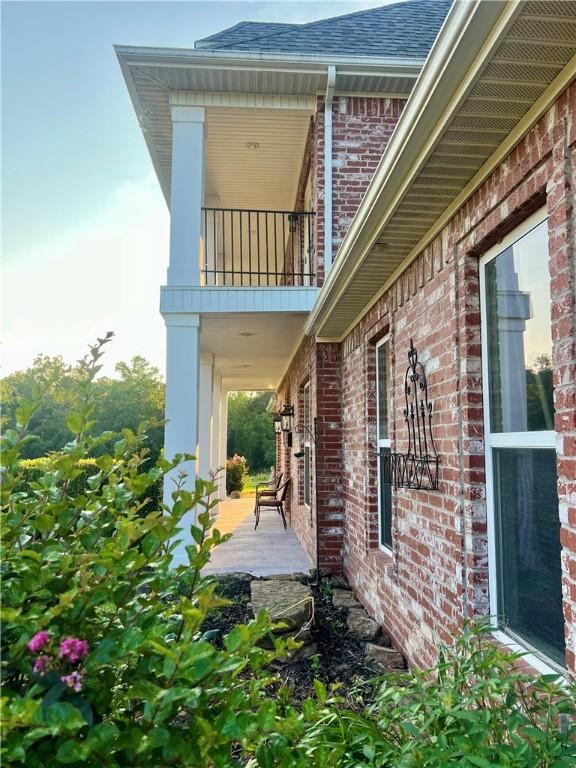 view of side of home featuring a balcony