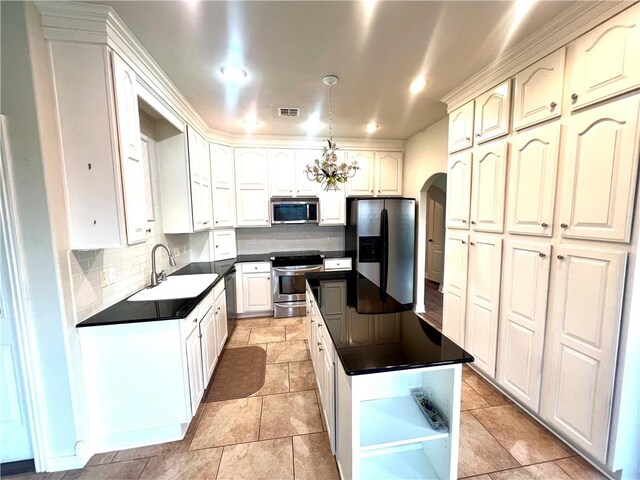 kitchen featuring sink, a kitchen island, light tile patterned floors, and stainless steel appliances