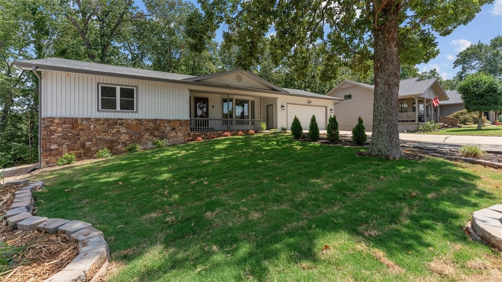 single story home with a garage and a front lawn