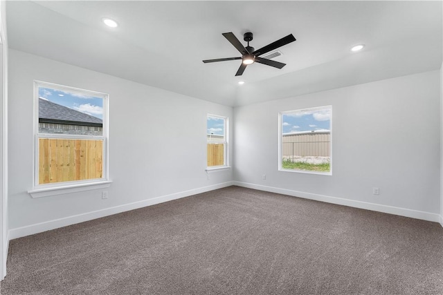 spare room featuring carpet, recessed lighting, a ceiling fan, vaulted ceiling, and baseboards