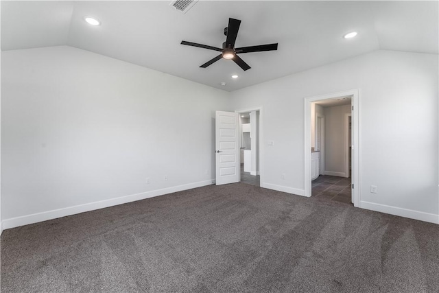 unfurnished bedroom featuring dark colored carpet, visible vents, vaulted ceiling, and recessed lighting