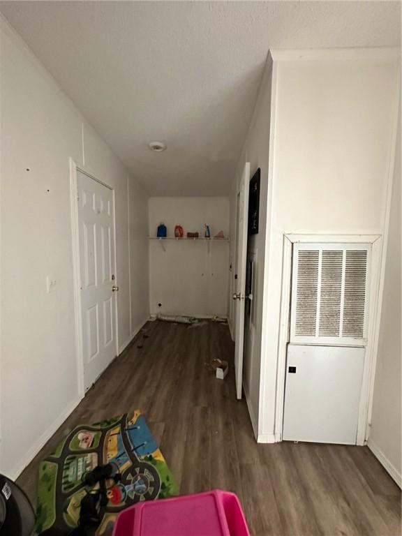 11121 Wolf Track Rd, Summers, AR 72769 - corridor featuring wood finished floors and a heating unit
