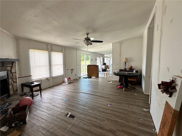 11121 Wolf Track Rd, Summers, AR 72769 - living area with a fireplace, ceiling fan, a textured ceiling, and wood finished floors