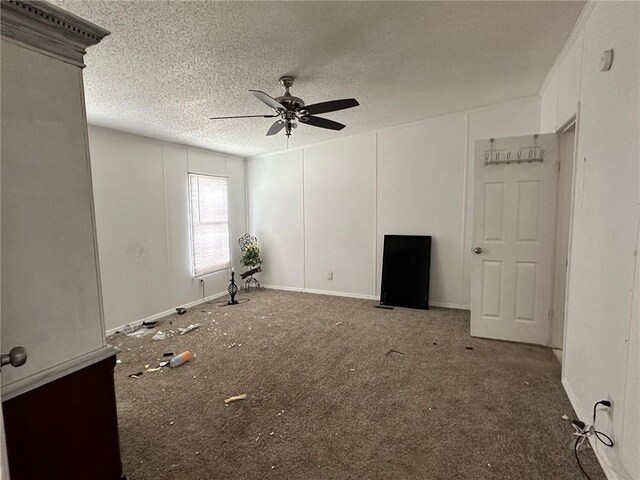 11121 Wolf Track Rd, Summers, AR 72769 - unfurnished living room featuring a ceiling fan, carpet flooring, a textured ceiling, and baseboards