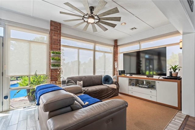 living room with hardwood / wood-style flooring and ceiling fan