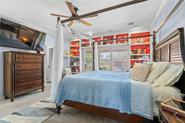carpeted bedroom with ceiling fan and ornamental molding