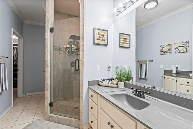 bathroom with vanity, crown molding, a shower with shower door, and tile patterned floors