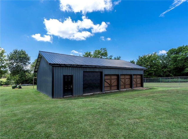 view of outbuilding featuring a garage and a yard