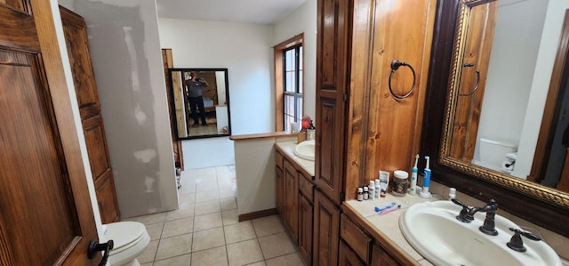 bathroom with tile patterned flooring, toilet, and vanity