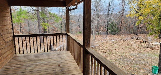 wooden terrace with a wooded view