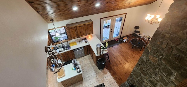 interior space featuring light hardwood / wood-style floors, high vaulted ceiling, wooden ceiling, and a chandelier