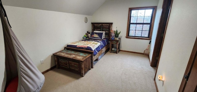 bedroom with carpet floors, baseboards, and vaulted ceiling