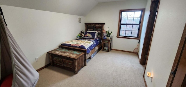 carpeted bedroom featuring lofted ceiling