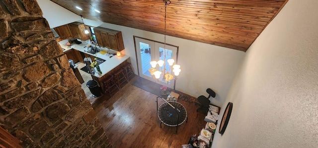 unfurnished living room with high vaulted ceiling, wooden ceiling, and dark hardwood / wood-style flooring