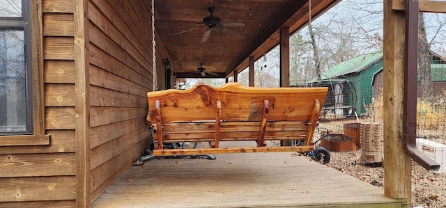 wooden terrace featuring ceiling fan