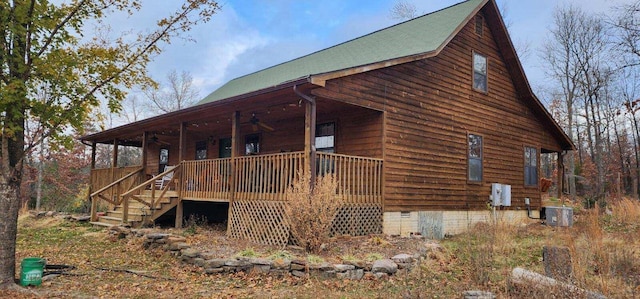 view of side of home with stairs, crawl space, central AC, and ceiling fan