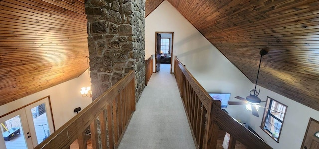 corridor featuring carpet, high vaulted ceiling, and wooden ceiling