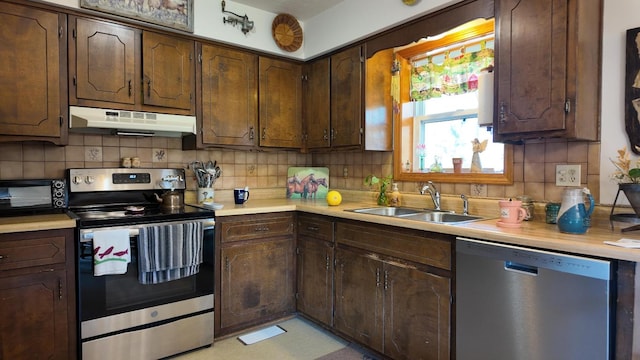 kitchen with sink, backsplash, dark brown cabinetry, and stainless steel appliances