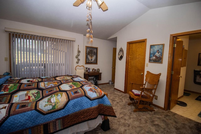 bedroom featuring carpet, vaulted ceiling, ceiling fan, and ensuite bath