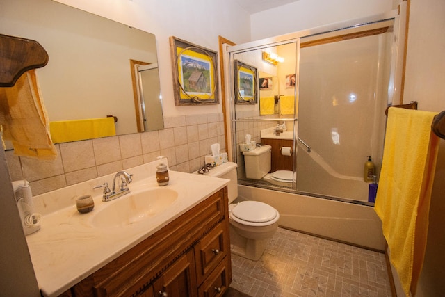 full bathroom featuring tasteful backsplash, tile patterned flooring, bath / shower combo with glass door, tile walls, and toilet