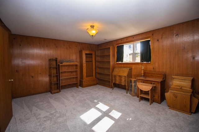 miscellaneous room with light colored carpet and wood walls