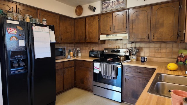 kitchen featuring sink, decorative backsplash, dark brown cabinets, and stainless steel appliances