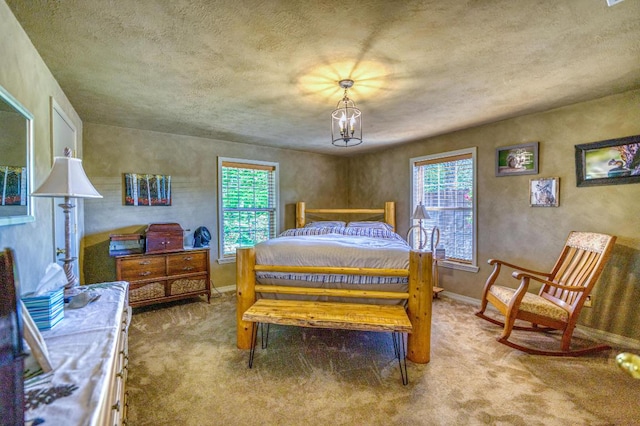 carpeted bedroom featuring multiple windows and a chandelier