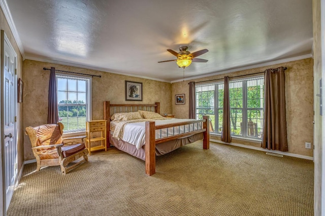 bedroom with ceiling fan, carpet floors, and ornamental molding