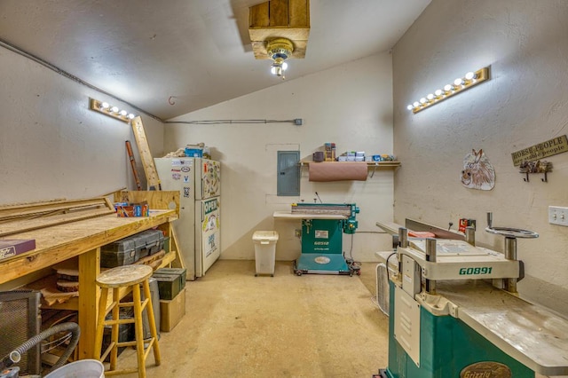 interior space with electric panel, white fridge, and a workshop area