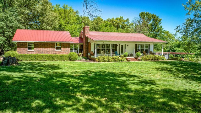 3128 Silver Valley Rd, Harrison, AR 72601 - rear view of house featuring a chimney, a yard, brick siding, and metal roof
