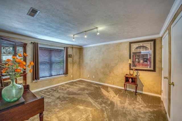 living area featuring rail lighting, carpet floors, ornamental molding, and a textured ceiling