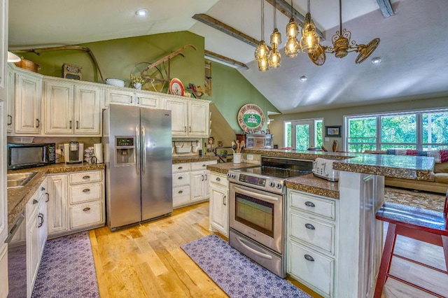 kitchen with kitchen peninsula, appliances with stainless steel finishes, light wood-type flooring, a breakfast bar, and hanging light fixtures