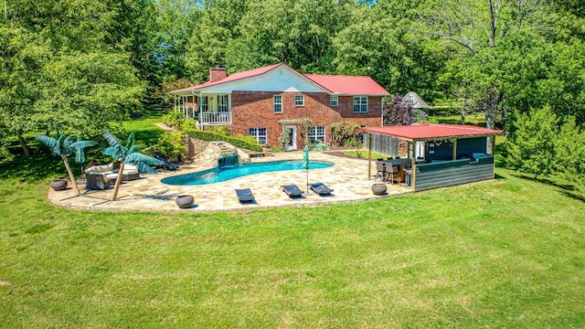 view of pool featuring a patio area and a lawn