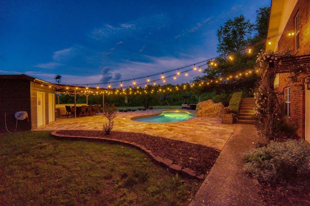 yard at dusk with a patio area and a fenced in pool