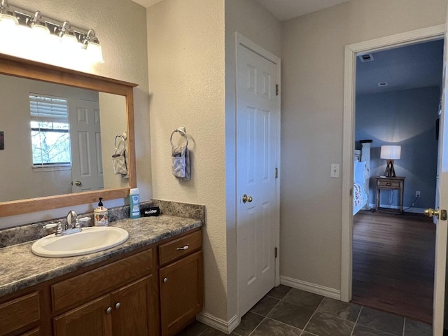 bathroom with tile patterned flooring and vanity