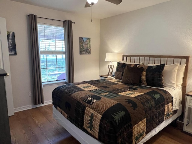 bedroom with dark hardwood / wood-style flooring and ceiling fan