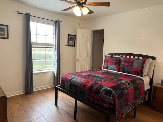 bedroom with wood-type flooring and ceiling fan