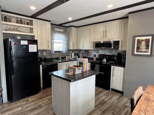 kitchen featuring light hardwood / wood-style flooring, black appliances, a center island, and sink