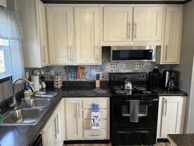 kitchen with black electric range, sink, and decorative backsplash