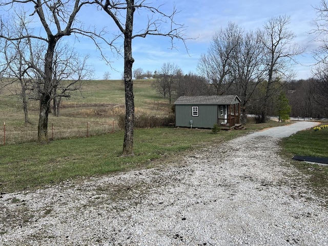 exterior space with a storage shed and a rural view