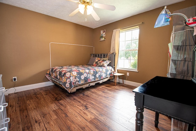 bedroom with wood-type flooring, ceiling fan, and a textured ceiling