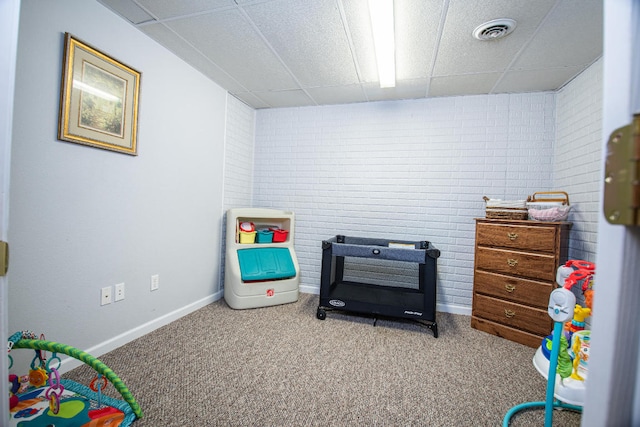 interior space with light colored carpet and brick wall