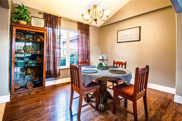 dining room featuring lofted ceiling, hardwood / wood-style floors, and a notable chandelier