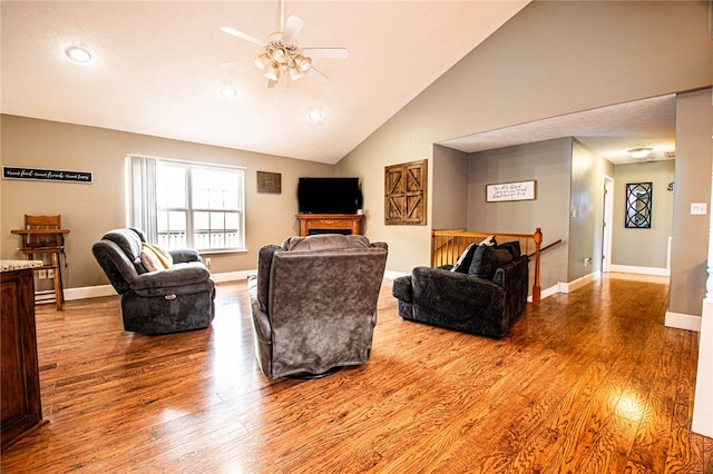 living room with high vaulted ceiling, wood-type flooring, and ceiling fan