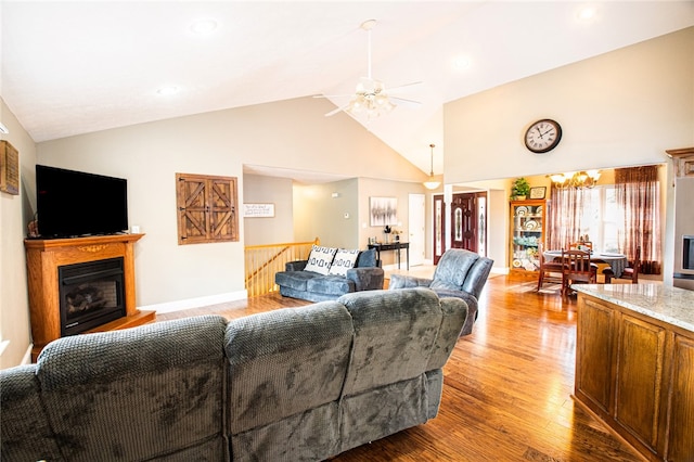 living room with high vaulted ceiling, wood-type flooring, and ceiling fan