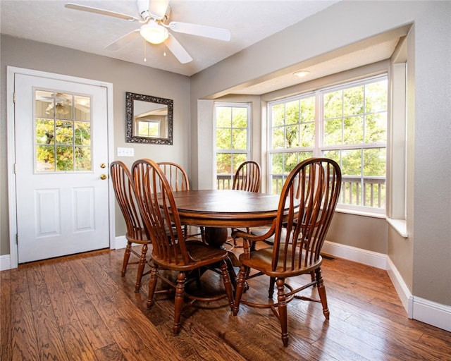 dining space with hardwood / wood-style floors and ceiling fan