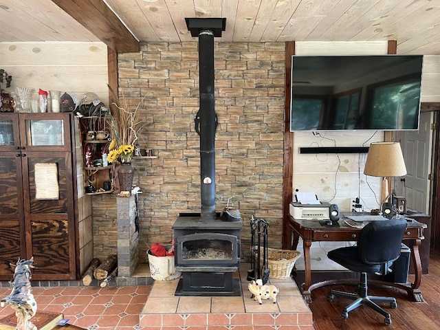 interior space featuring wooden walls, hardwood / wood-style floors, a wood stove, and wooden ceiling