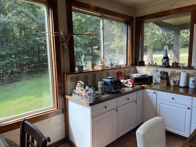 kitchen with white cabinetry and tasteful backsplash